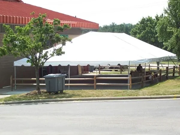 White canopy tent near brick building