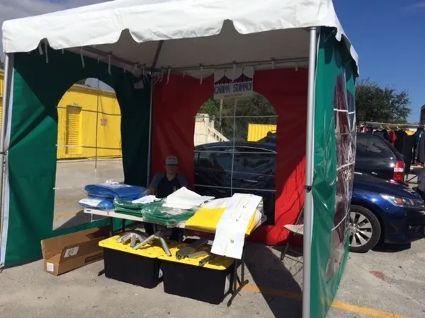 Outdoor market tent with table display.
