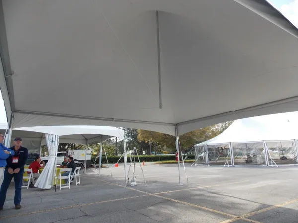 Outdoor event with large tents and seating