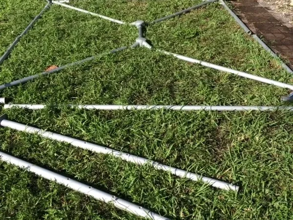 Metal frame structure on green grass