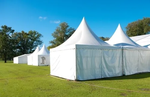 White tents on green grass field