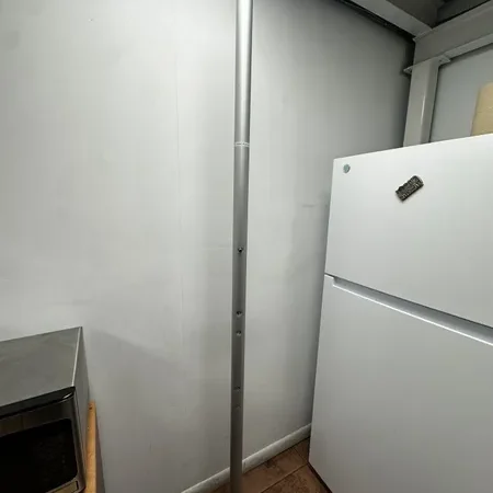 Vertical pole beside kitchen appliances