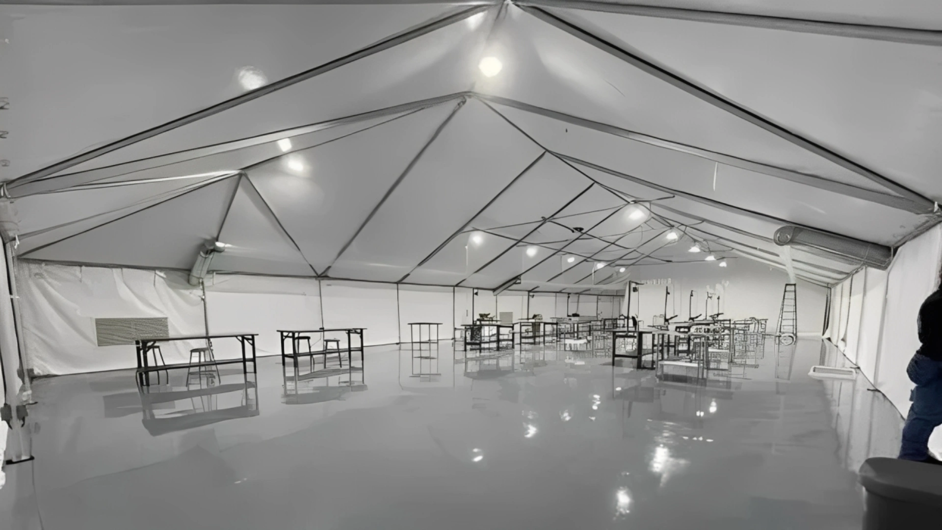 Industrial tent setup with minimal furnishings