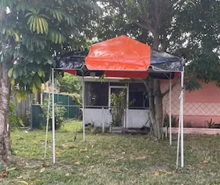 Orange canopy tent in a backyard