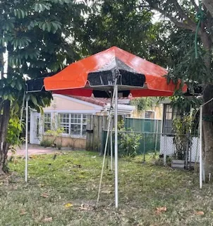 Red canopy tent in backyard