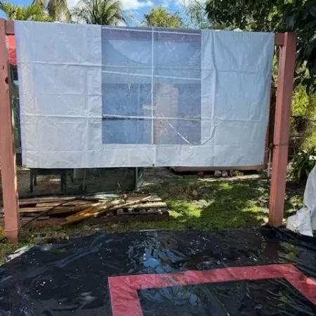 Outdoor movie screen setup with tarp