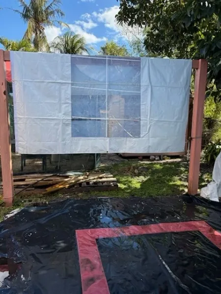 Outdoor movie screen setup with tarp
