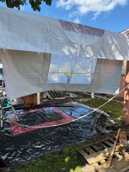 Outdoor DIY tarp shelter in backyard